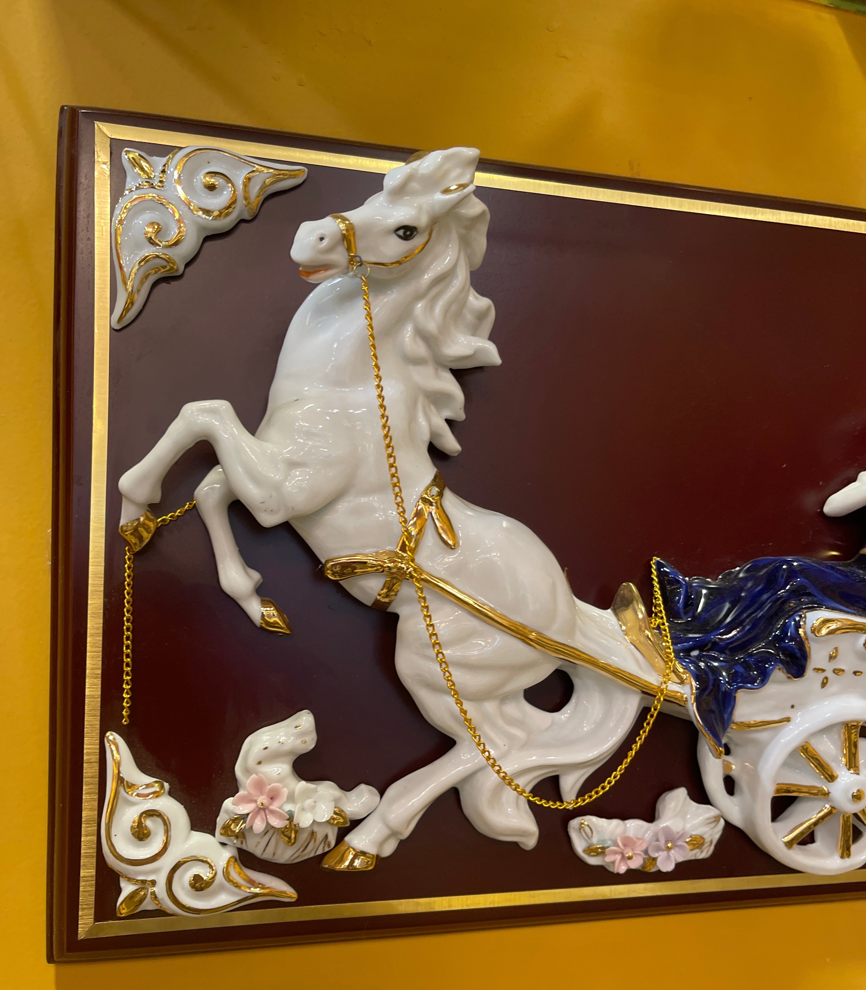 Lady in blue riding horse carriage in ceramic