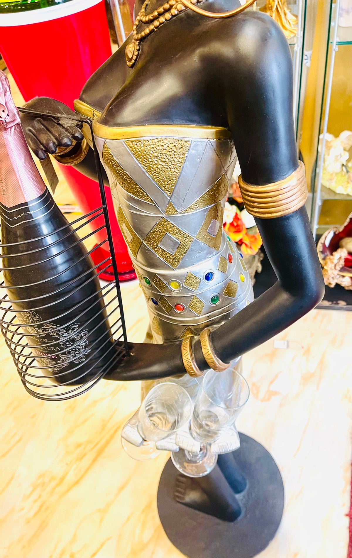 African woman holding a champagne bottle with glasses