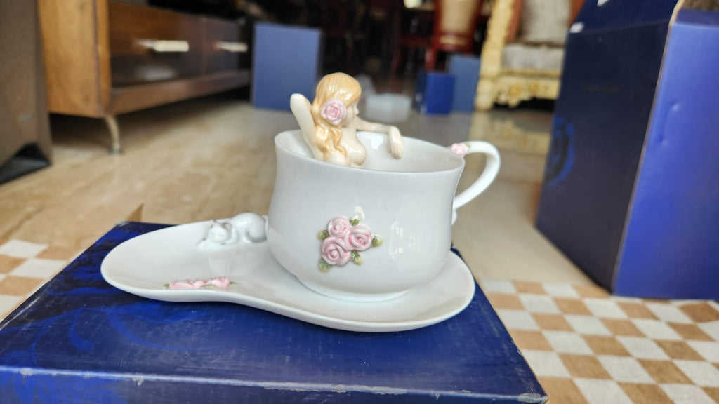 Cup and saucer with a nude lady in the cup