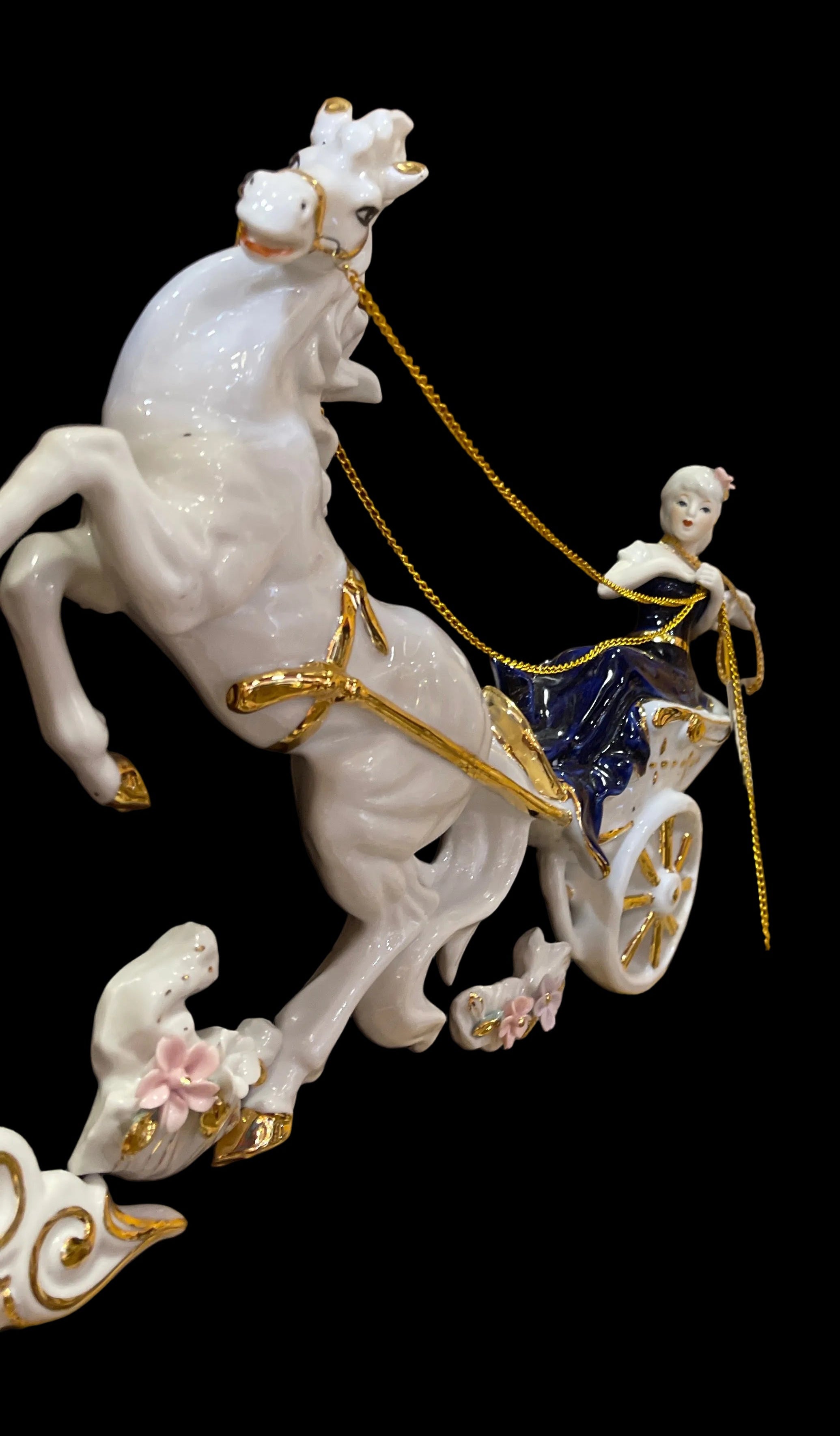 Lady in blue riding horse carriage in ceramic