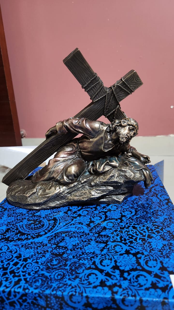Jesus Christ Caring a cross in bronze color