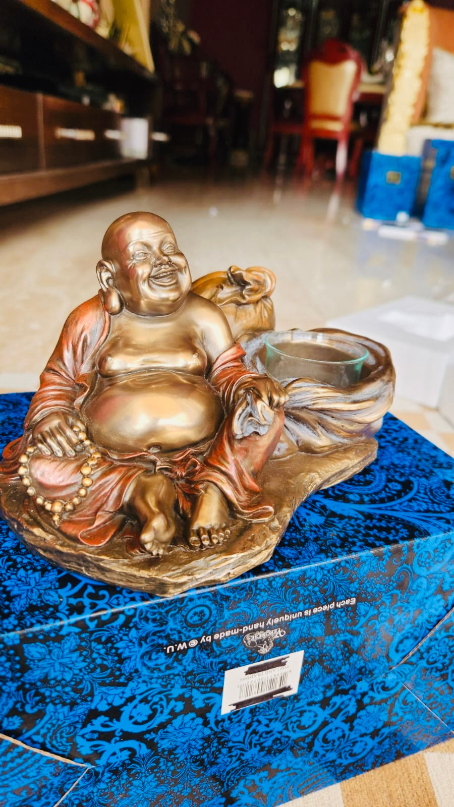 Laughing Buddha in Bronx with the candleholder