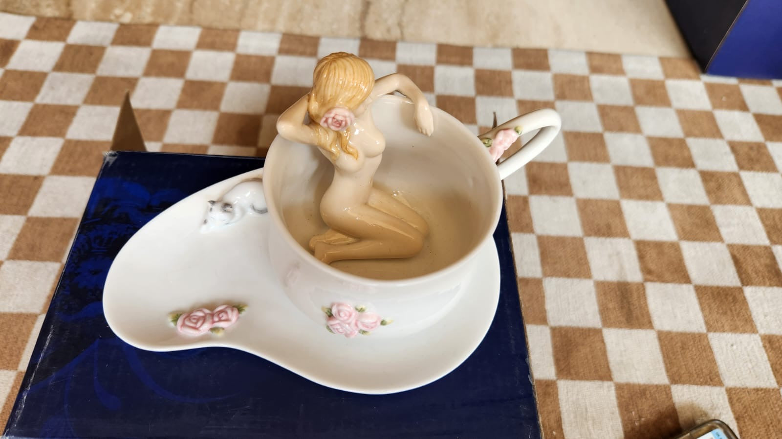 Cup and saucer with a nude lady in the cup
