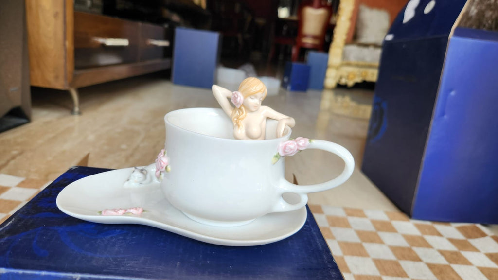 Cup and saucer with a nude lady in the cup