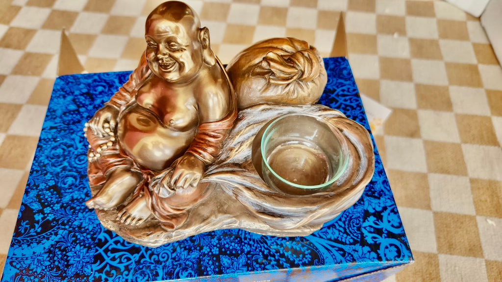 Laughing Buddha in Bronx with the candleholder