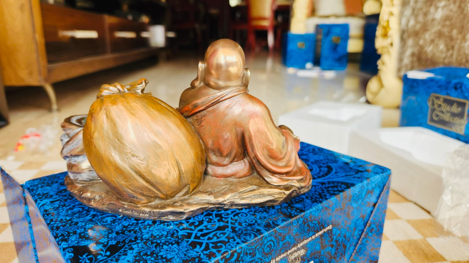 Laughing Buddha in Bronx with the candleholder